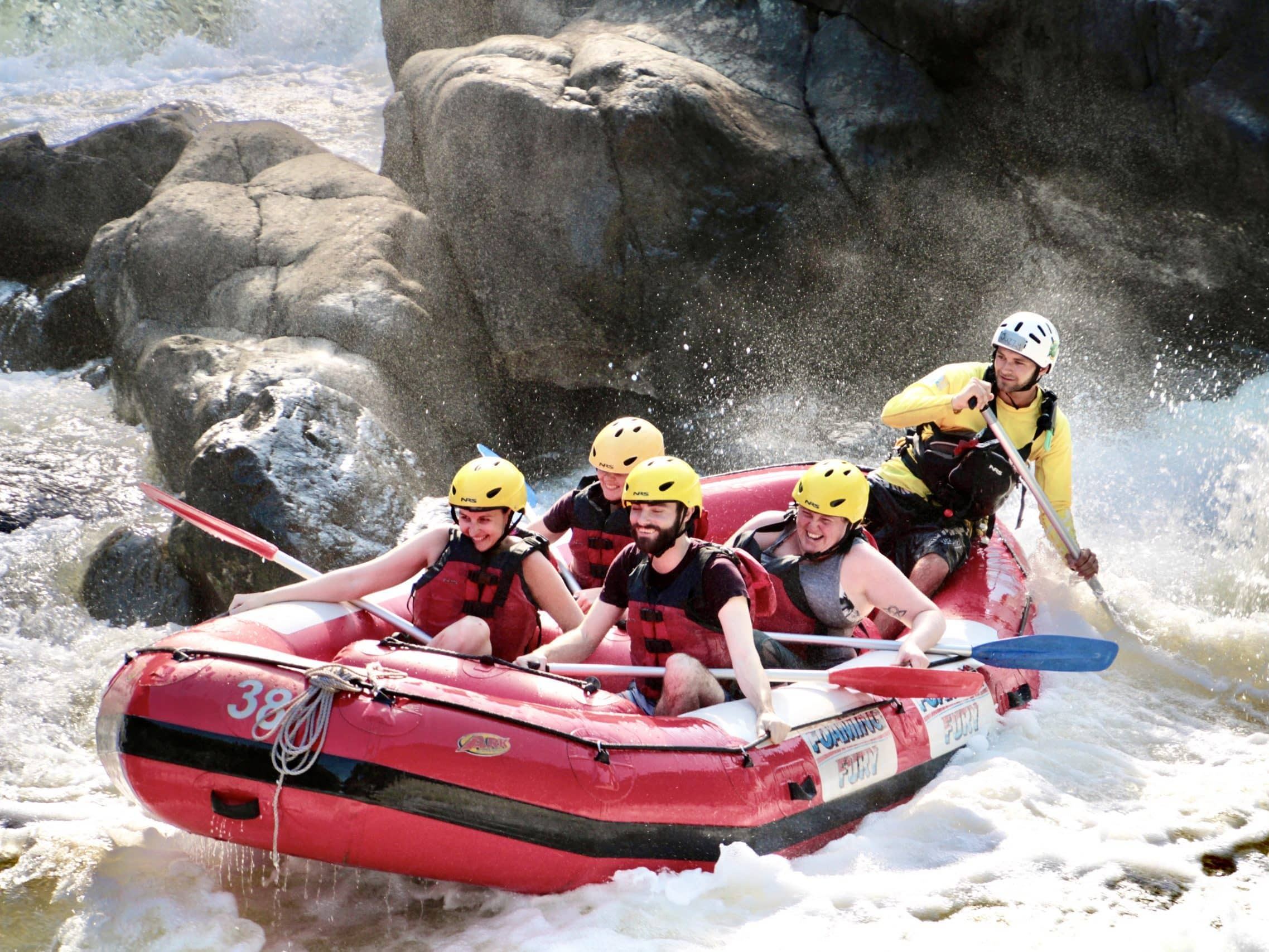 A guided rafting group paddling through rapids near Cairns
