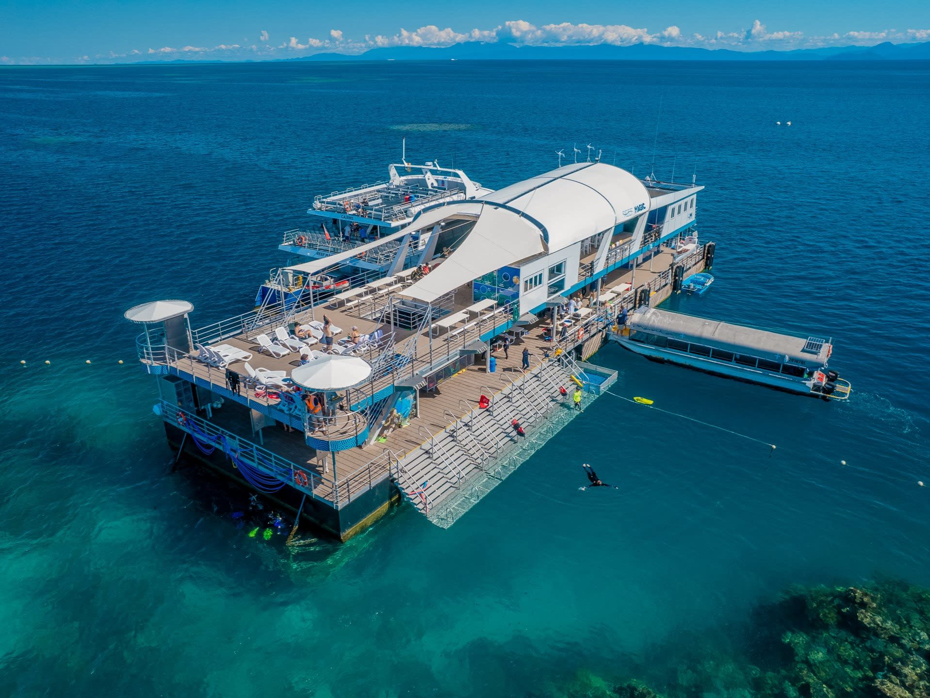 Reef Magic pontoon surrounded by blue water at Moore Reef